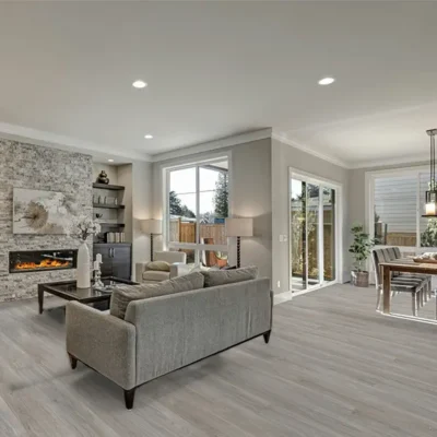 AGT Natura Lena Oak laminate flooring installed in a modern open plan living and dining area with soft grey oak tones
