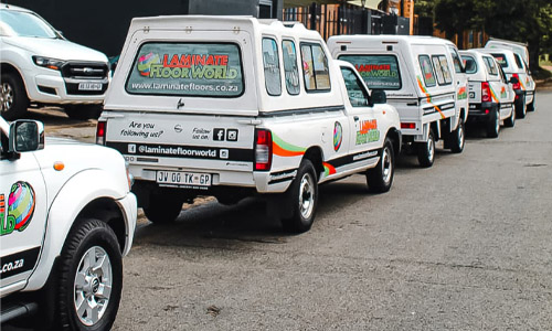 Laminate Floor World branded installation vehicles parked in a row