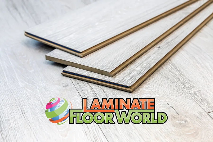 Laminate flooring and vinyl flooring in South Africa – light wood textured panels stacked on floor with Laminate Floor World logo